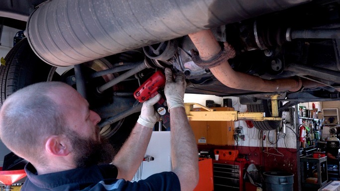 the mechanic fixes the car exhaust Stewarts Donnybrook Auto Tyler TX